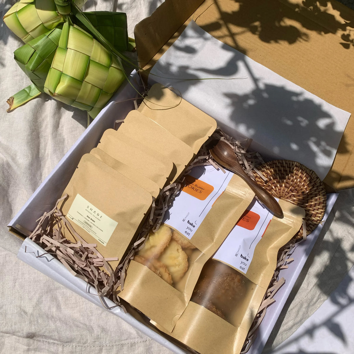 Gift set with Shade Botanicals Tea Blend and a plant on a textured surface