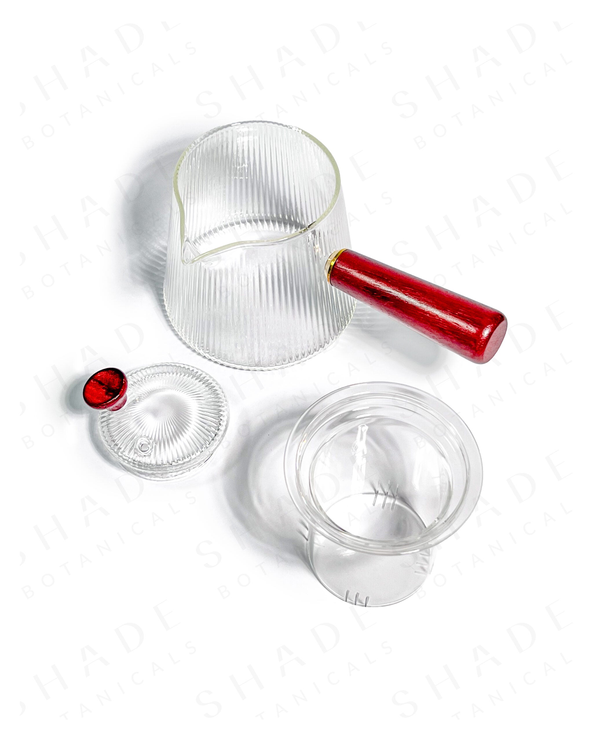 Shade Botanicals red handle serrated teapot top view with lid and parts opened