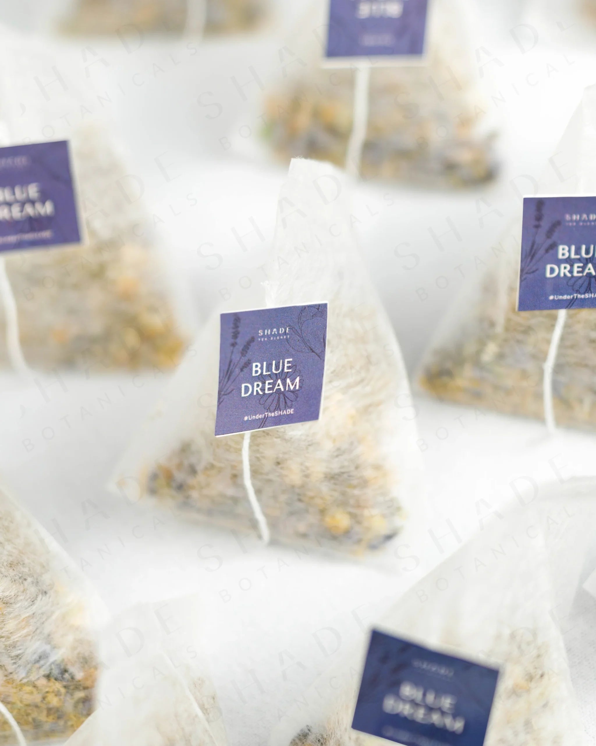 Shade Botanicals Blue Dream loose leaf tea inside a small tea pack