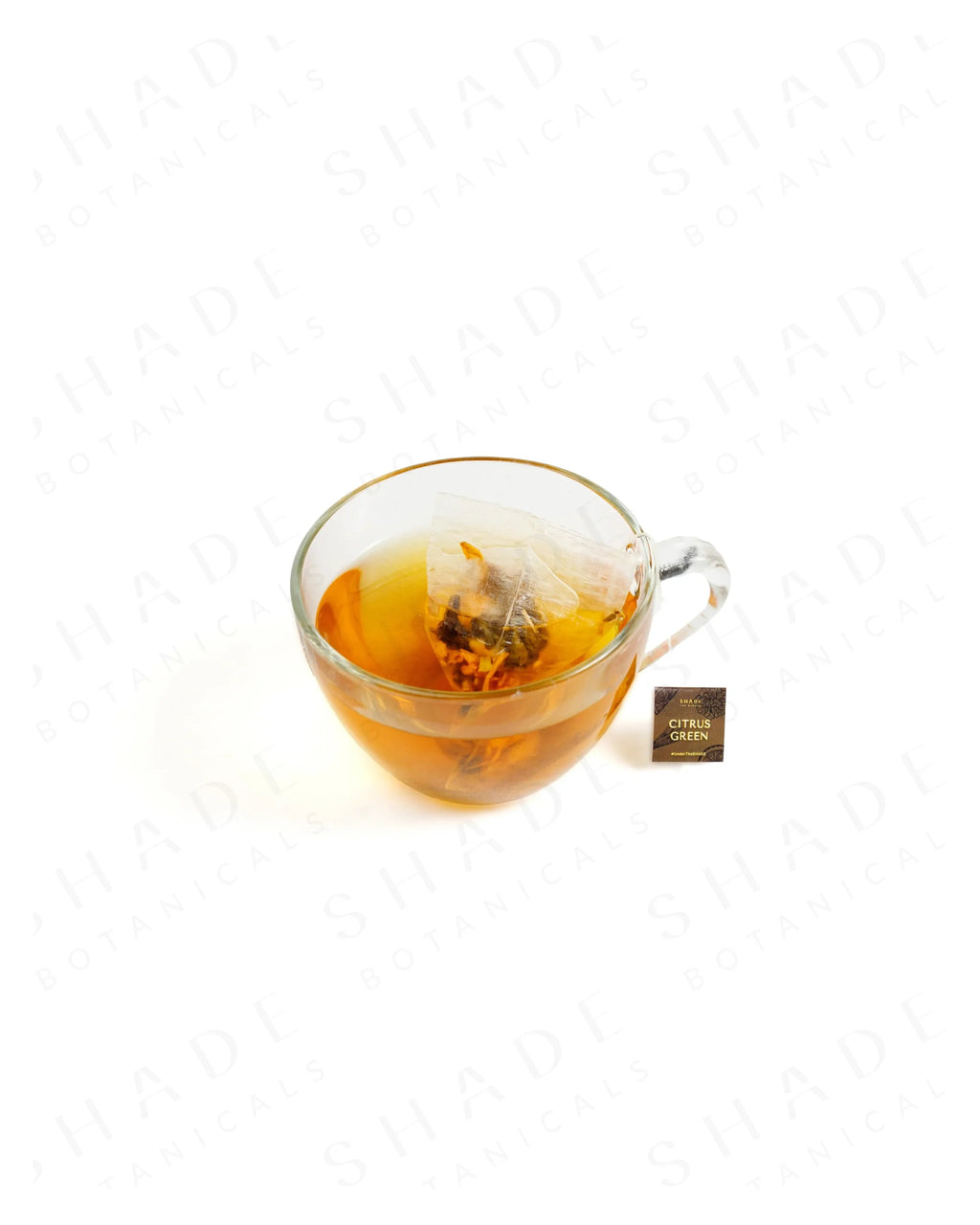 Shade Botanicals Citrus Green loose leaf tea served in a glass cup