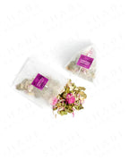 Top view of Shade Botanicals Moringa Melody loose leaf tea slightly spilled from a small tea pack