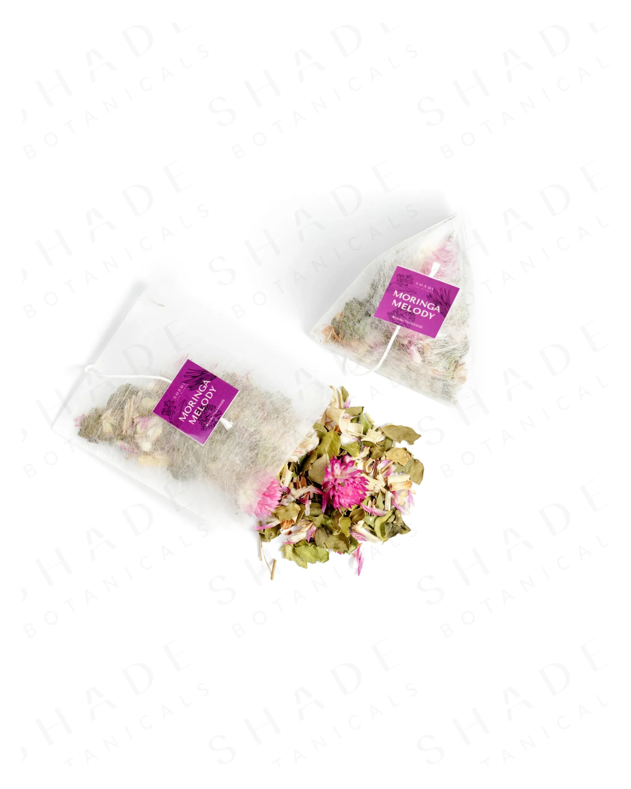 Top view of Shade Botanicals Moringa Melody loose leaf tea slightly spilled from a small tea pack