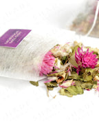 Shade Botanicals Moringa Melody loose leaf tea slightly spilled from a small tea pack