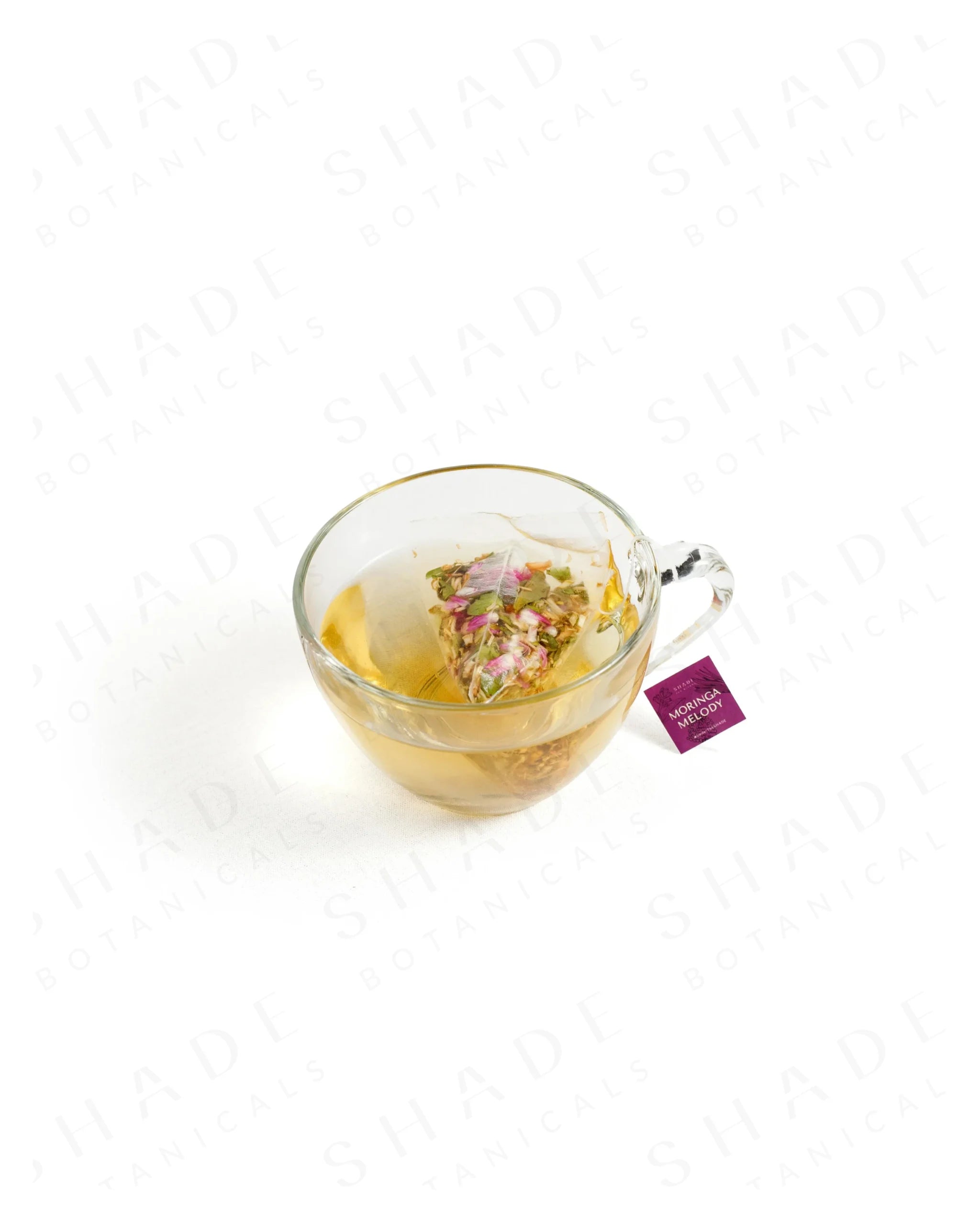 Shade Botanicals Moringa Melody loose leaf tea served in a glass cup