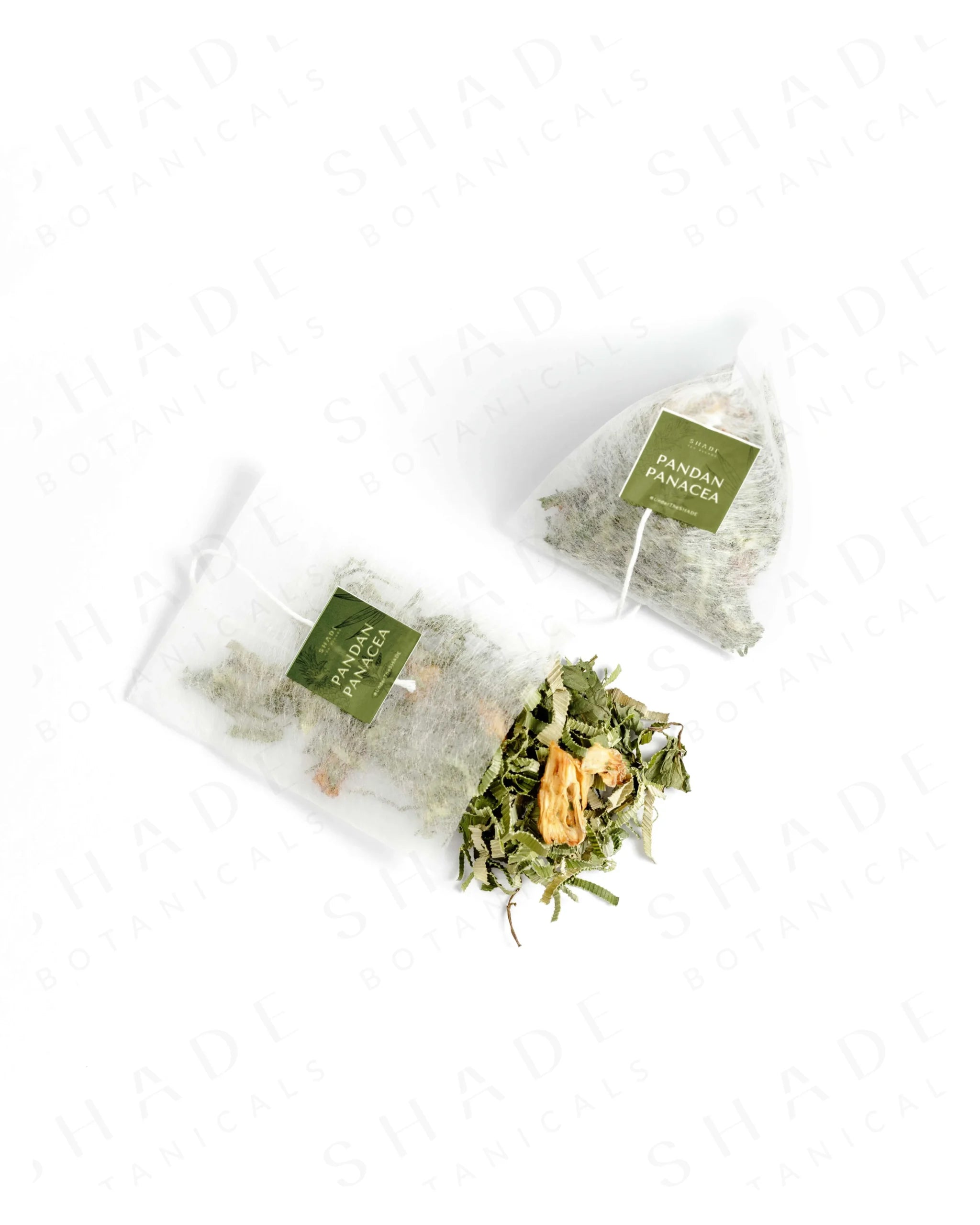 Top view of Shade Botanicals Pandan Panacea loose leaf tea slightly spilled from a small tea pack