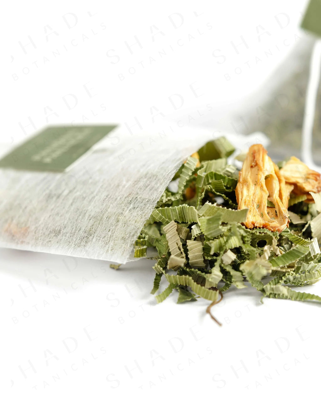 Shade Botanicals Pandan Panacea loose leaf tea slightly spilled from a small tea pack
